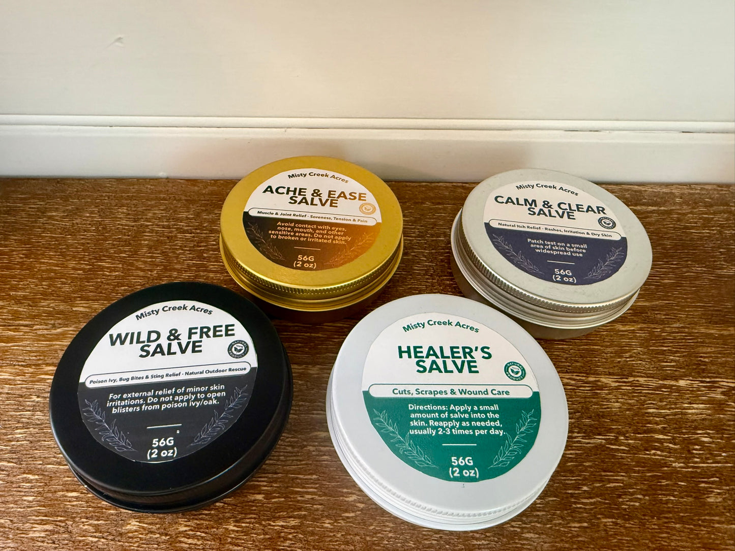 Collection of salve containers on a wooden surface