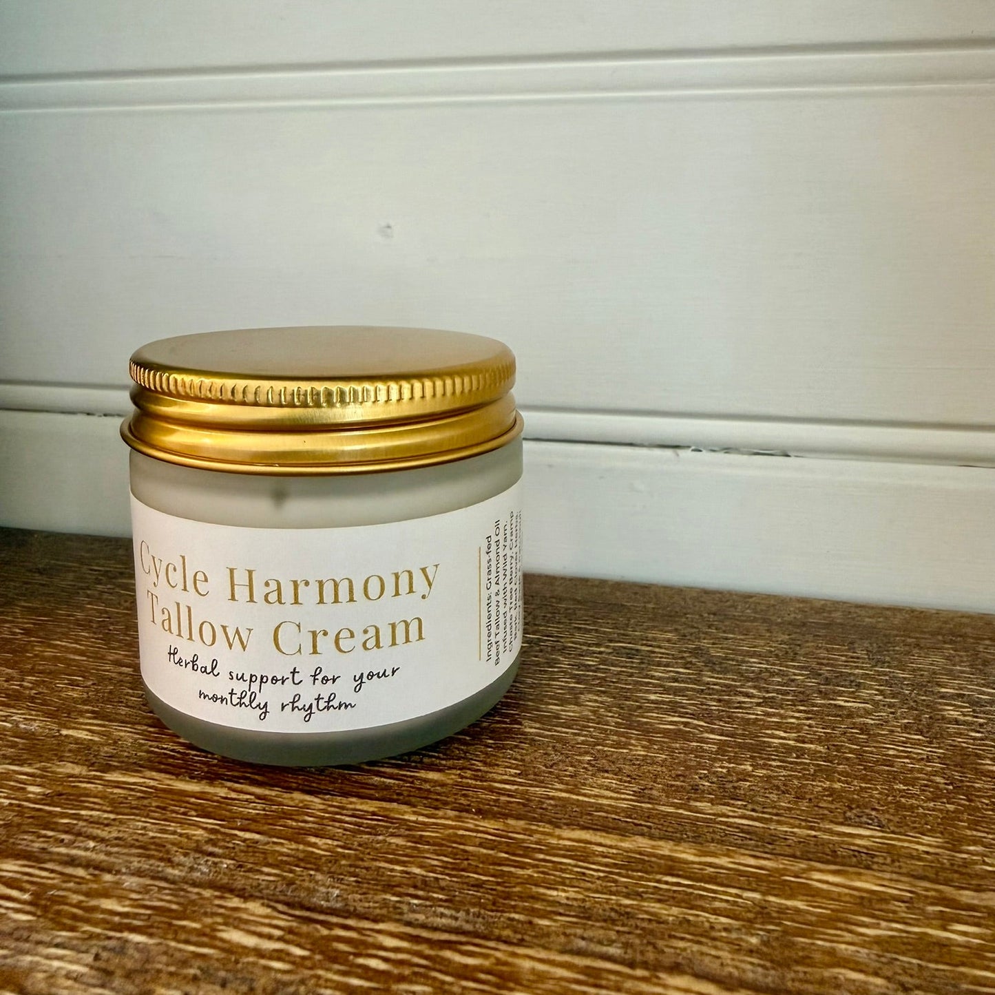 Jar of Cycle Harmony Yellow Cream on a wooden surface with a white wall background