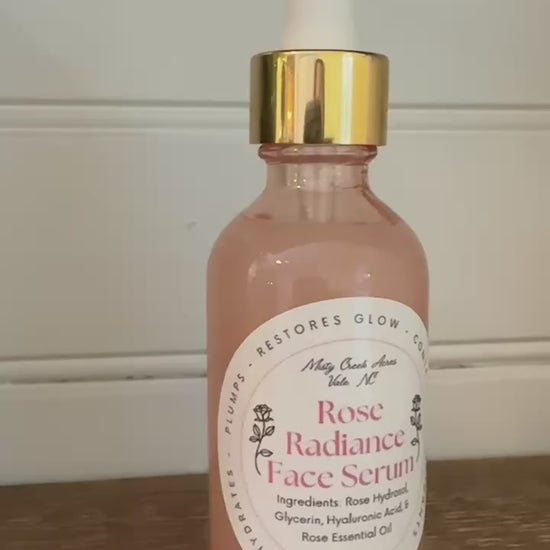 Rose Radiance Face Serum bottle with dropper on a wooden surface