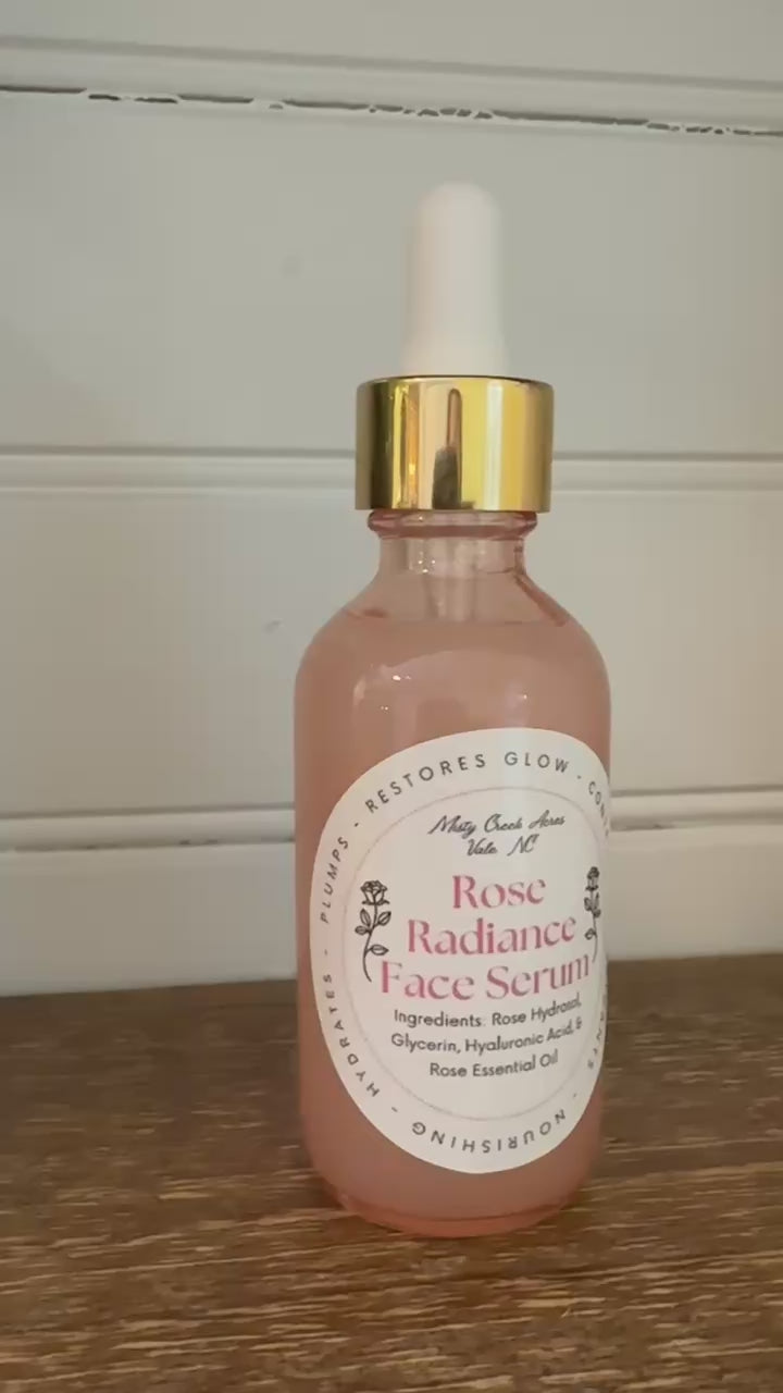 Rose Radiance Face Serum bottle with dropper on a wooden surface